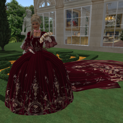 Mme. wearing a  red Velvet gown from Alisha.